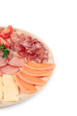 Various cheese on wooden platter.