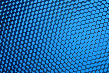 Close up of black net. Blue light.
