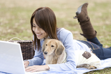 woman using PC with dog