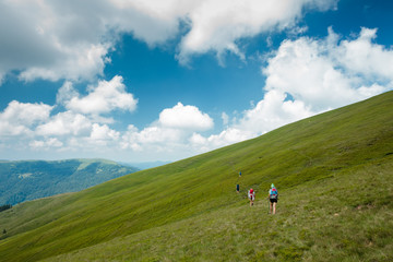 Fototapeta na wymiar Young people are hiking in Carpathian mountains in summertime