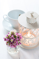pink flowers and candle lantern