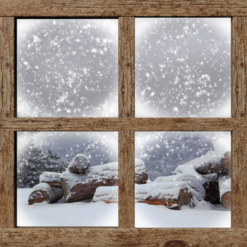 Winter outdoors view with firewood pile from wooden window