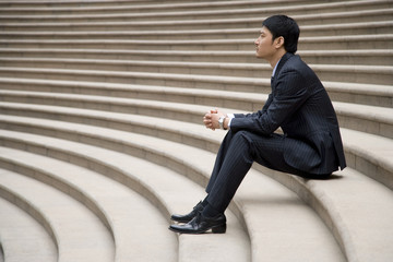 businessman sitting on stairs