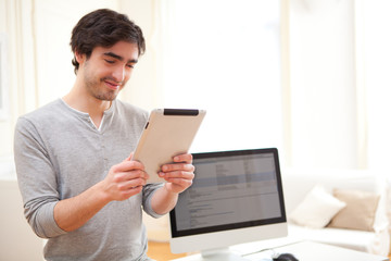 Young man using a tablet at the office