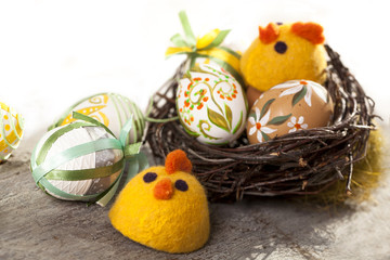 Easter eggs in nest on rustic wooden planks
