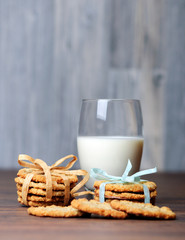A glass of milk and butter biscuits with bows