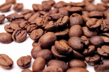 Macro shot of coffee beans on a white surface