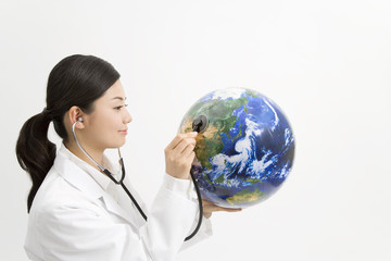 female doctor examining earth