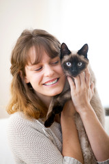 View of a young atractive girl with her cat