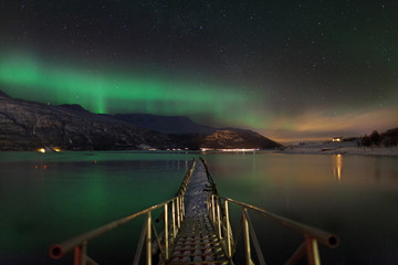 Aurora borealis over a norwegian fjord - 61994861