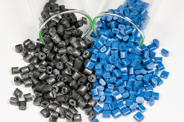 blue and black polymer pellets in test tubes