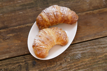 Sugar powder croissants on a plate