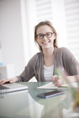 beautiful young woman working on her laptop in her office