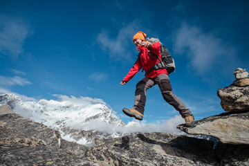 Fototapeta premium Hiker jumps in Himalaya mountains