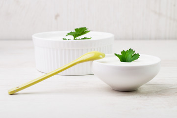 Two white bowls with milk product