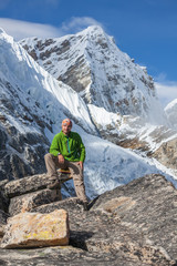 Hiker posing in Himalayas in front of big mountains