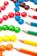Coloring pencils pointing at candy pattern