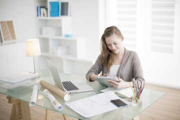 Fototapeta premium beautiful young woman on the workplace using a digital tablet