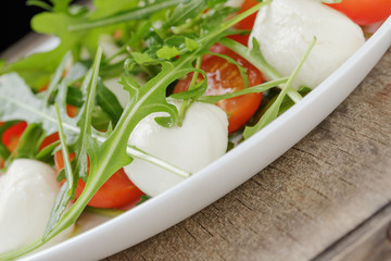 salad from arugula tomatos and baby mozzarella