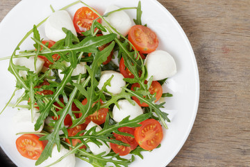 salad from arugula tomatos and baby mozzarella