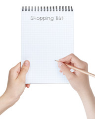 female teen girls holding notepad with shopping list