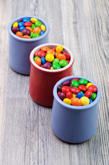 Three jars with delicious colorful candies