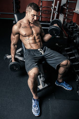 Fototapeta na wymiar Muscular man excersing in the gym