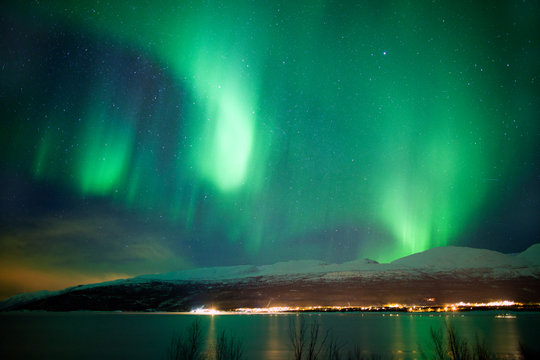 Green aurora borealis dancing in the sky