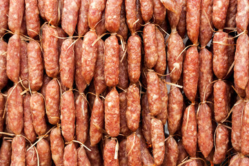 Hand made smoked sausages for sale hanging at asian food market