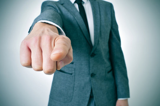 man in suit pointing the finger