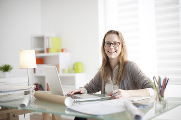 beautiful young woman sitting at her desk in the workplace