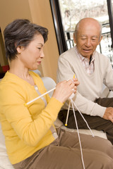 senior woman knitting and senior man