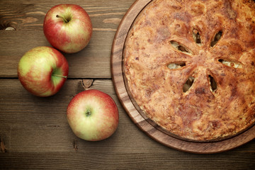 American apple pie on a wooden table, top view