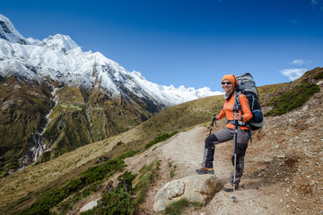 Hiker posing in Himalayas in front of big mountains
