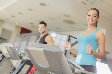 Young man and woman training in the gym