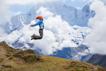 Naklejka na ściany i meble Hiker jumps in Himalaya mountains