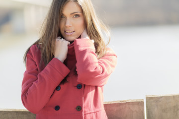 Pretty young woman in red coat