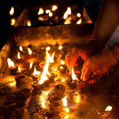 People burning oil lampsl in Hindu temple