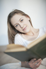 closeup of a beautiful young woman reading a book