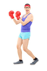 Young man with boxing gloves, posing