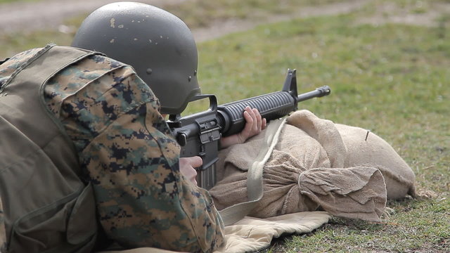 Soldier  shooting from M16 rifle