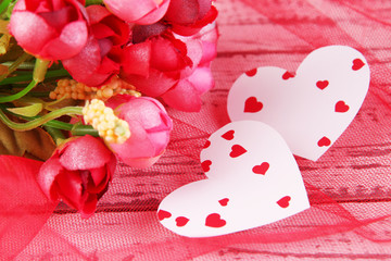 Paper hearts with flowers on table close up