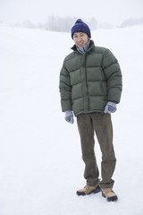 Fototapeta na wymiar man standing still in snowy field