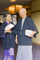 senior couple in yukata coming to hot spring