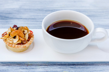 Black coffee and Fruit Tart  on wooden table