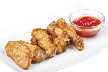 Grilled chicken drumsticks on white