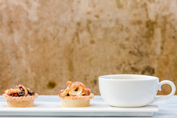 Black coffee and Fruit Tart  on wooden table
