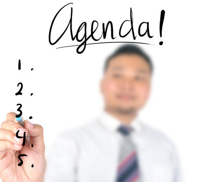 Businessman writing agenda