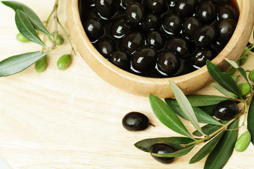 Olives with green leaf on background