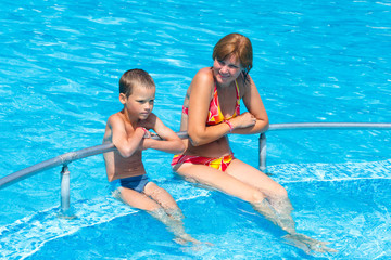 Mother with her son in the pool.